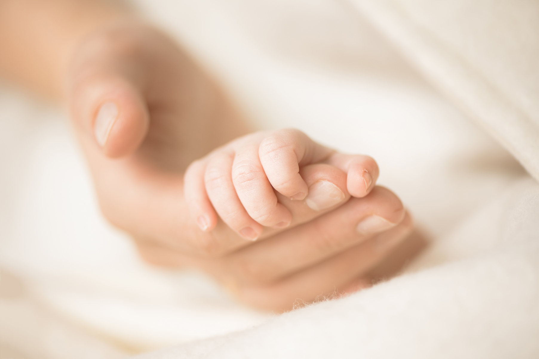 Hand Holding Newborn Baby